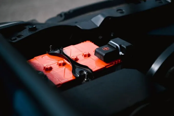Car battery inside a vehicle engine bay